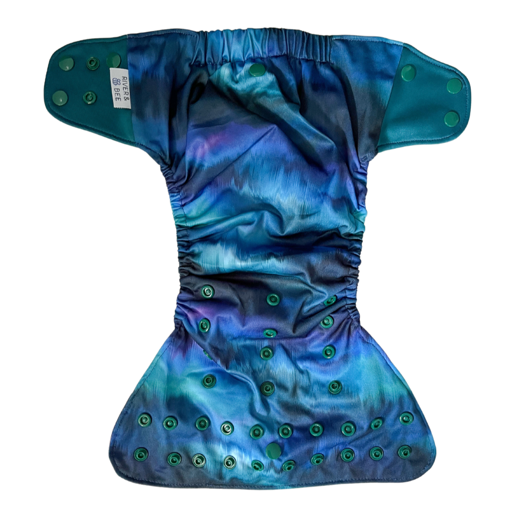 Reusable modern cloth nappy in the print Aurora.